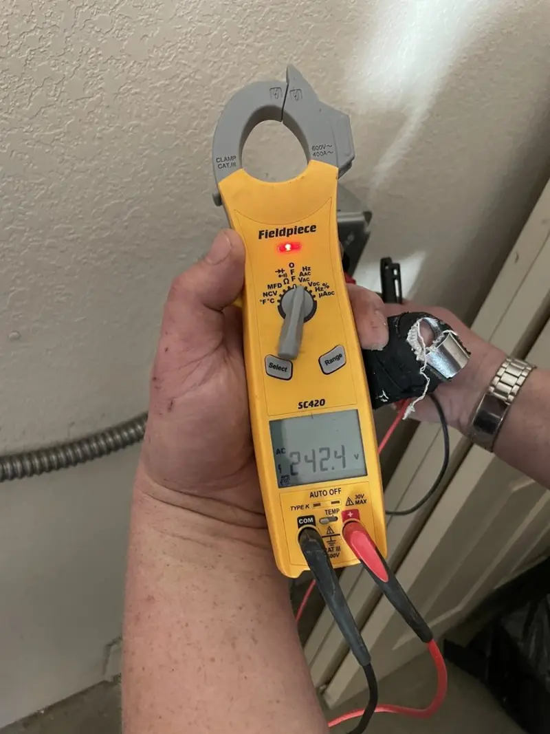 Voltage testing with clamp meter during Ceiling Fan Installation in Pipestone